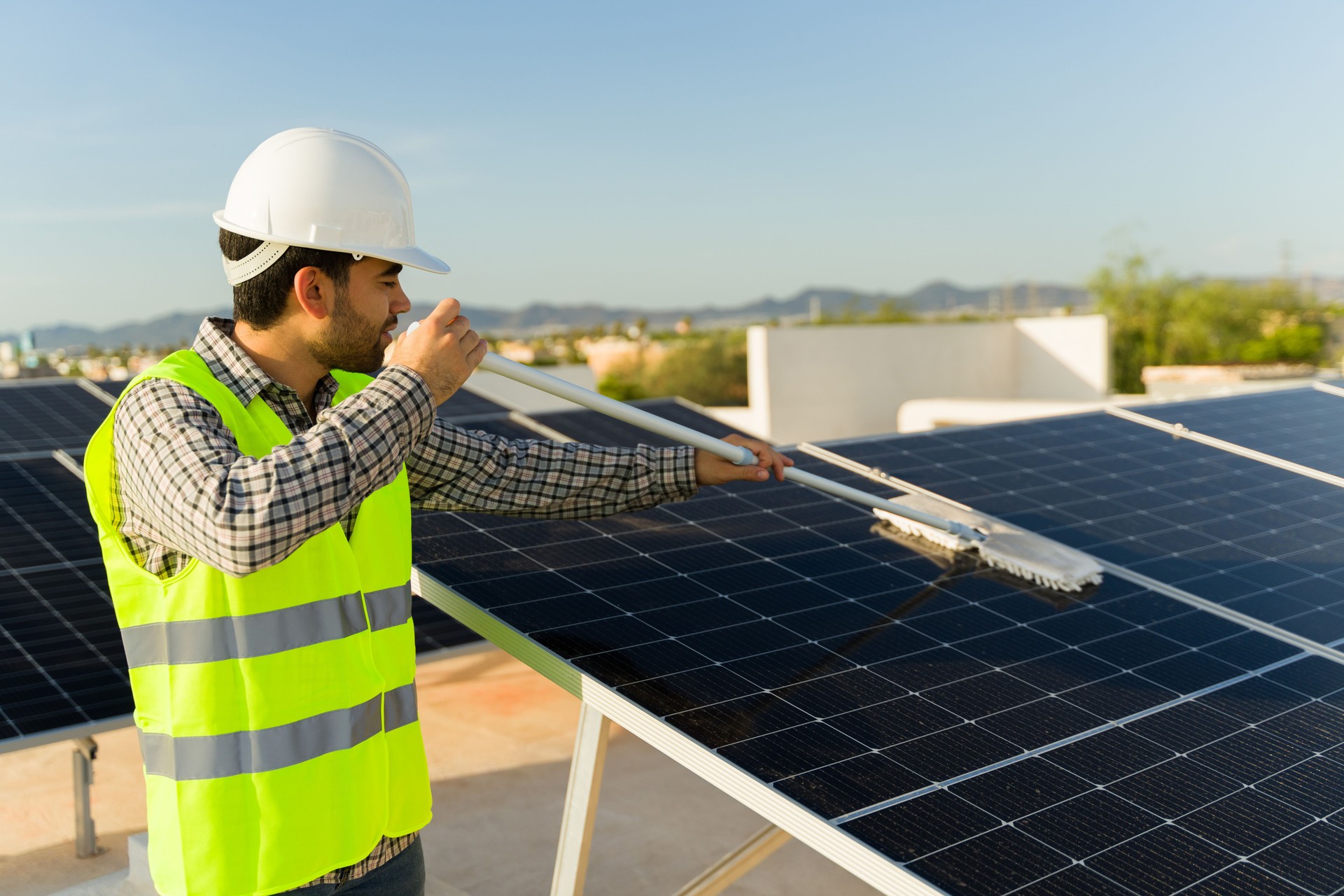 Young man engineer working cleaning the solar panels